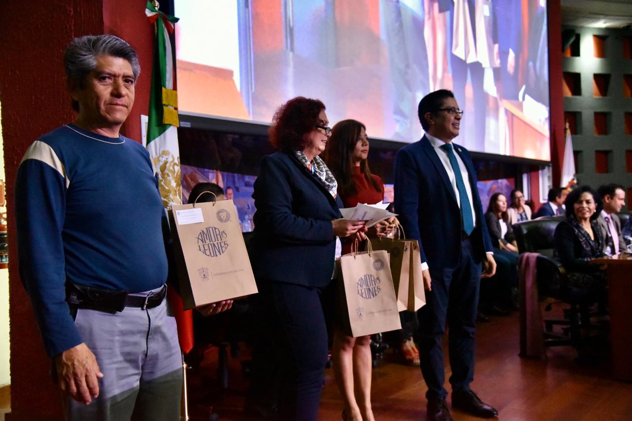 rector cucs posando para la foto con padres de familia que ganaron paquetes de libros