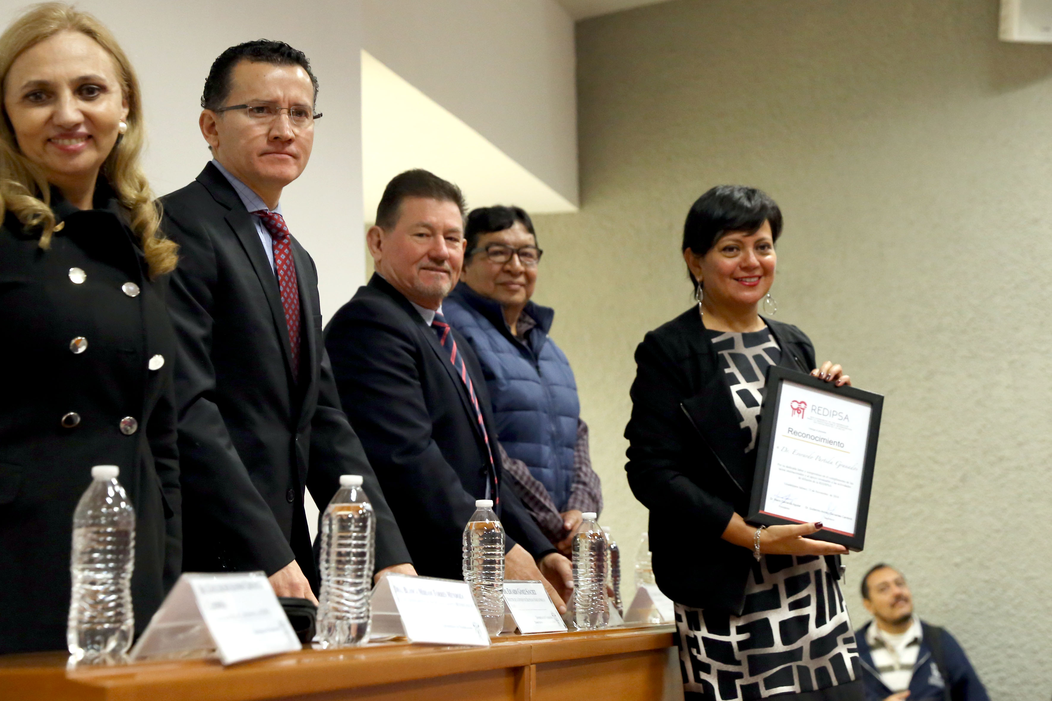 Miembros del presídium entregan reconocimiento a la Coordinación General de Comunicación Social