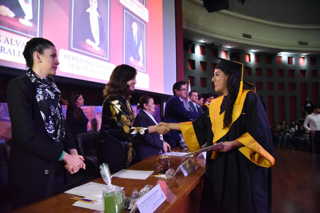 Rector entregando constancia a graduada