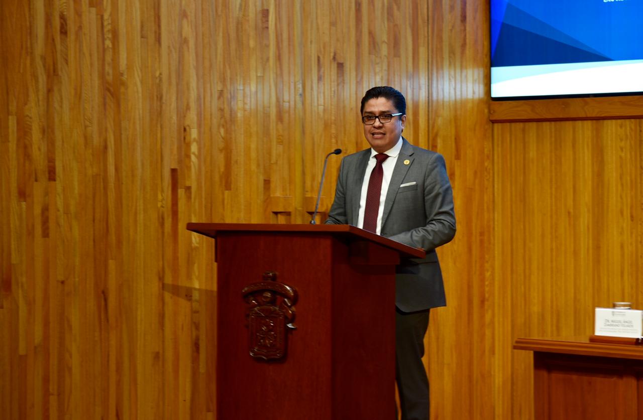 Dr. Muñoz dirigiendo mensaje desde el pódium en el Paraninfo