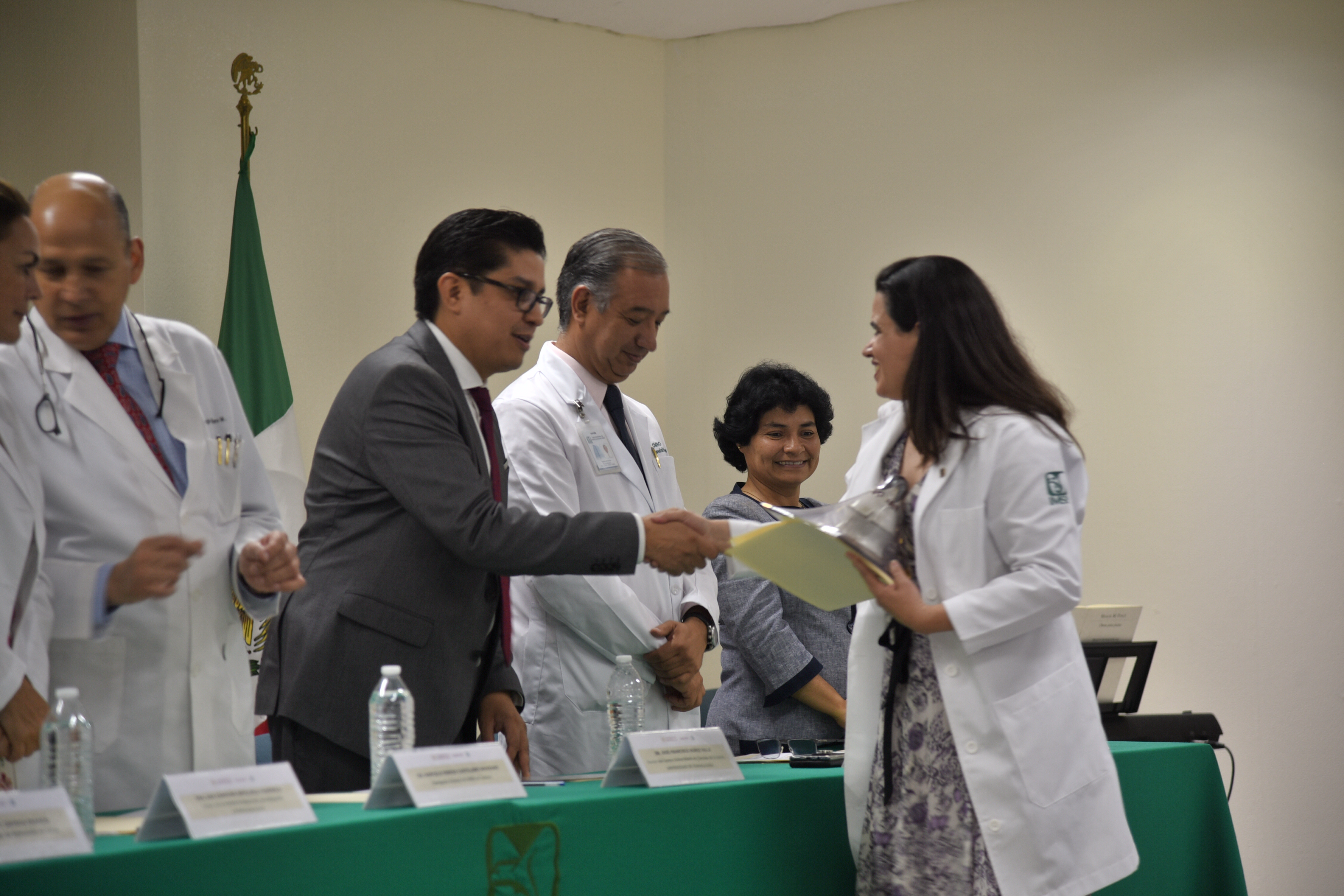 Rector del Cucs entregando reconocimiento a médico docente del IMSS
