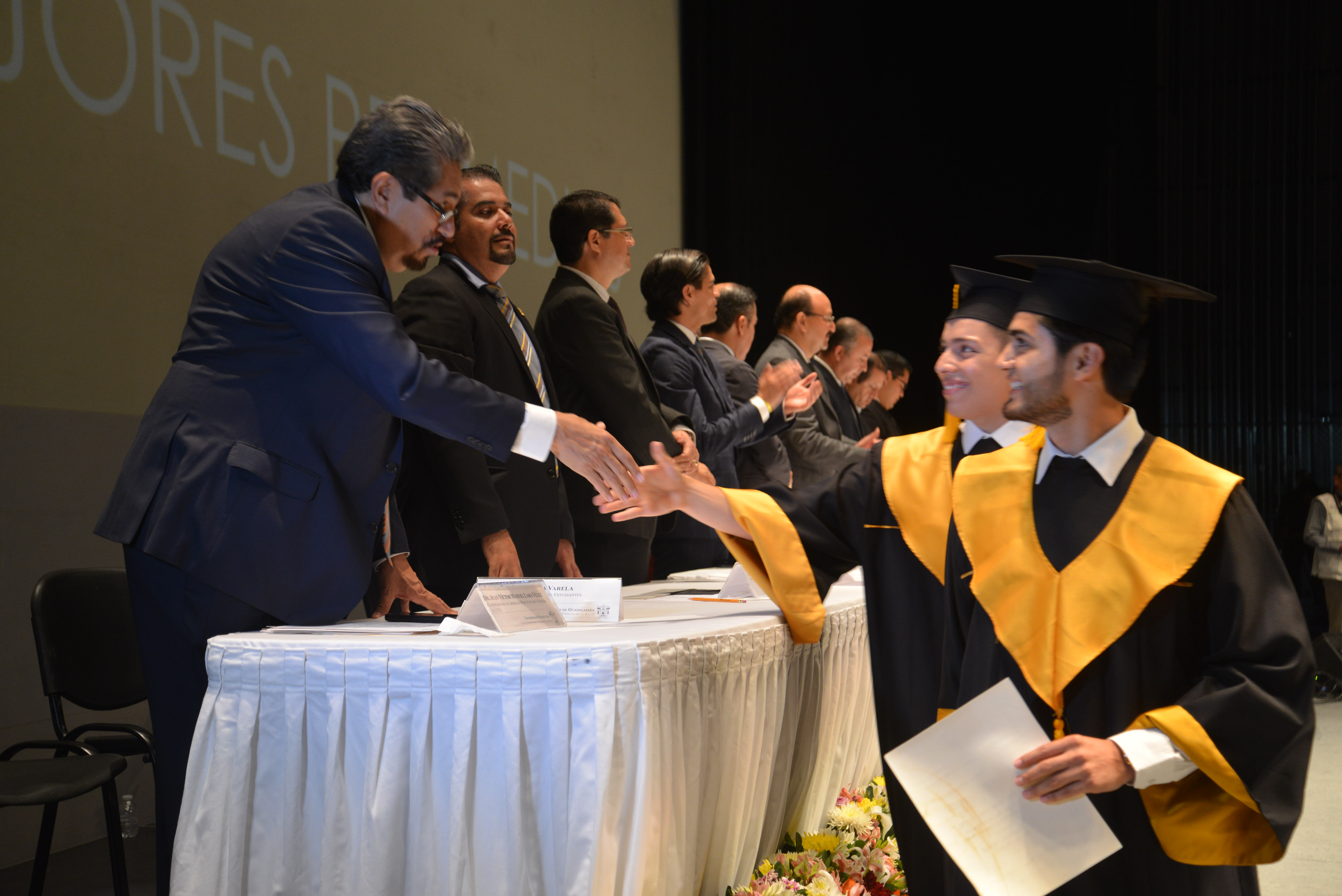 Alumno graduado recibiendo diploma