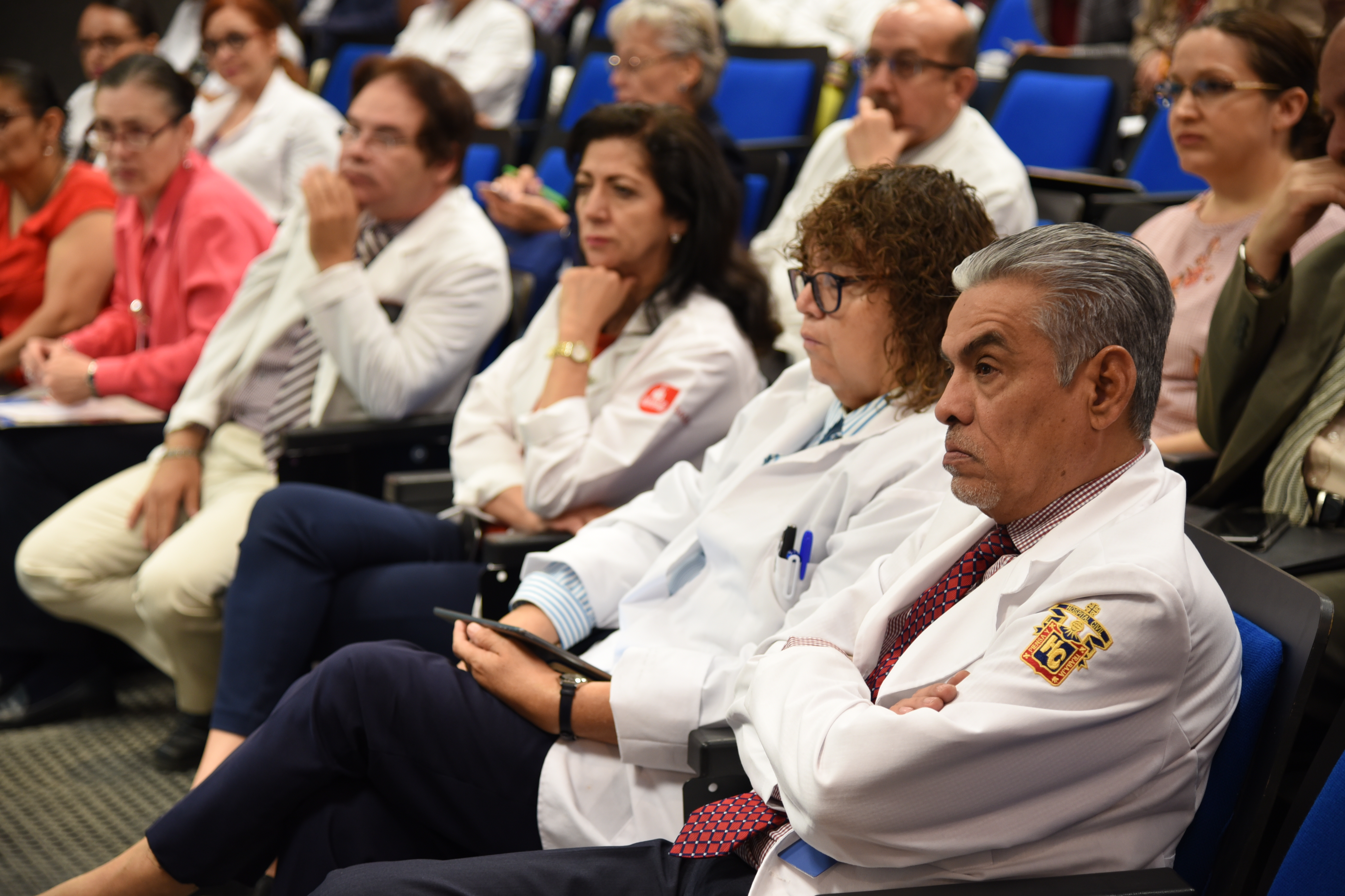 Investigadores del CUCS con su bata blanca asistentes al evento