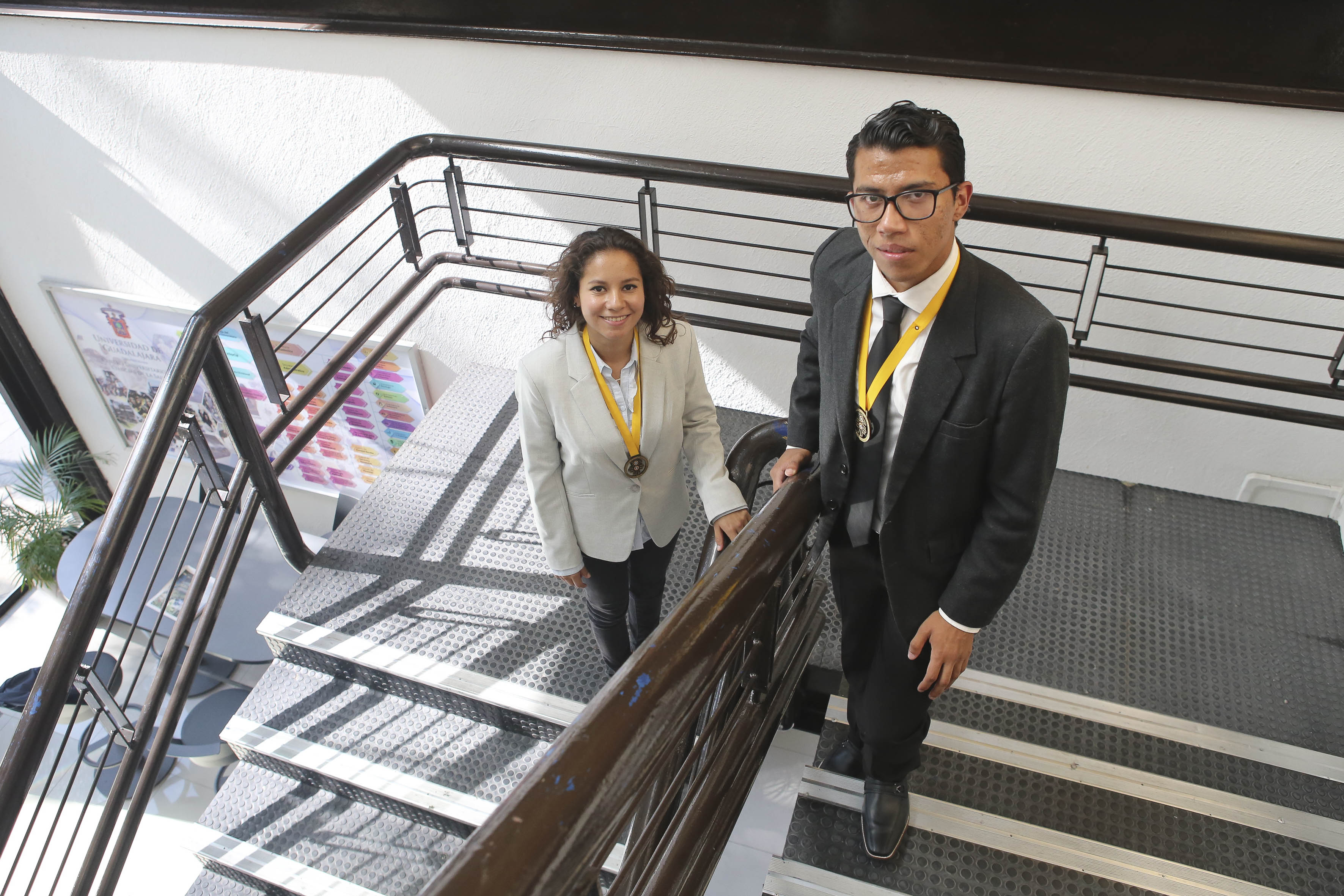 Alumnos ganadores posando en las escaleras de Rectoría mirando hacia arriba