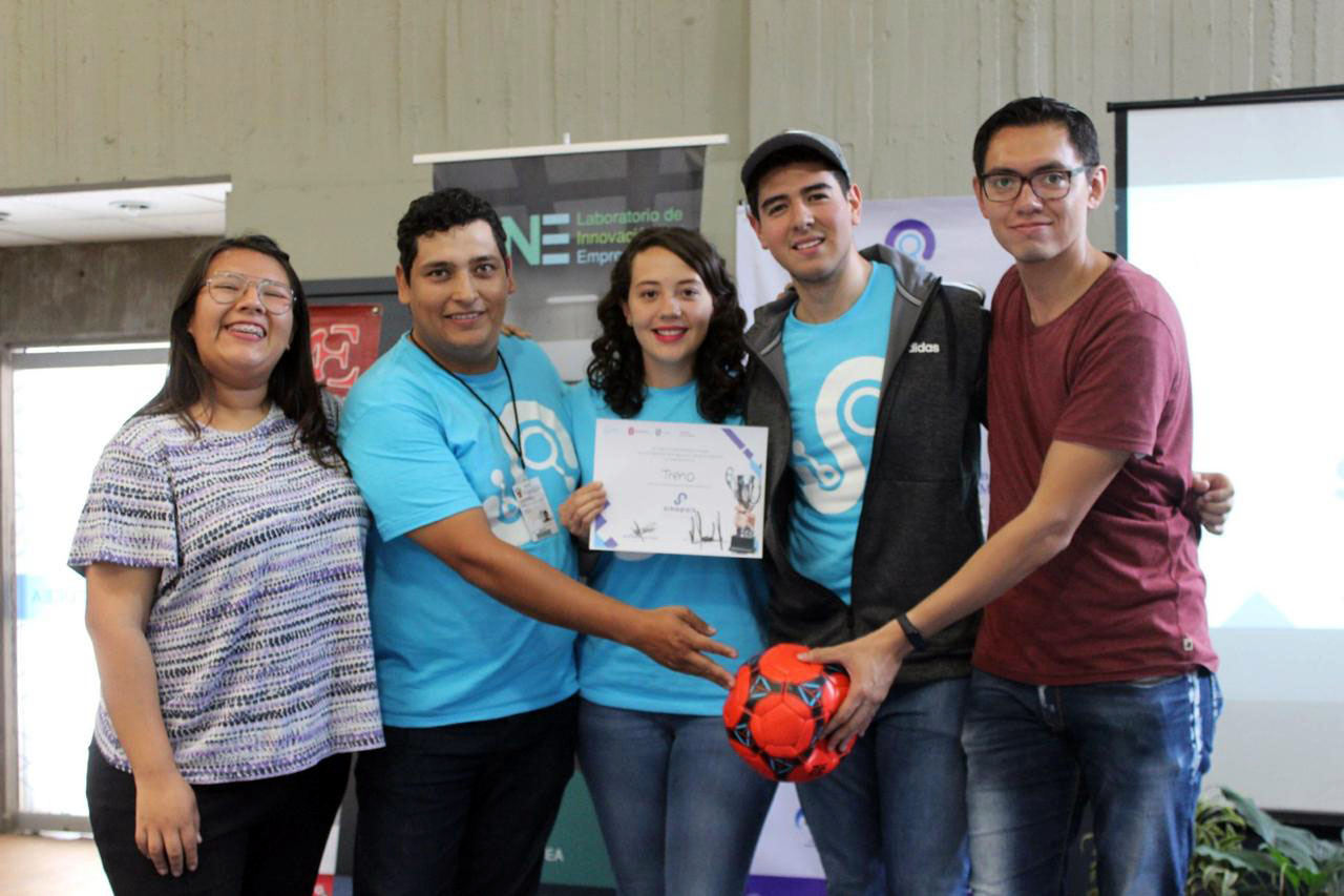 Equipo de ganadores posan para la foto exhibiendo su reconocimiento