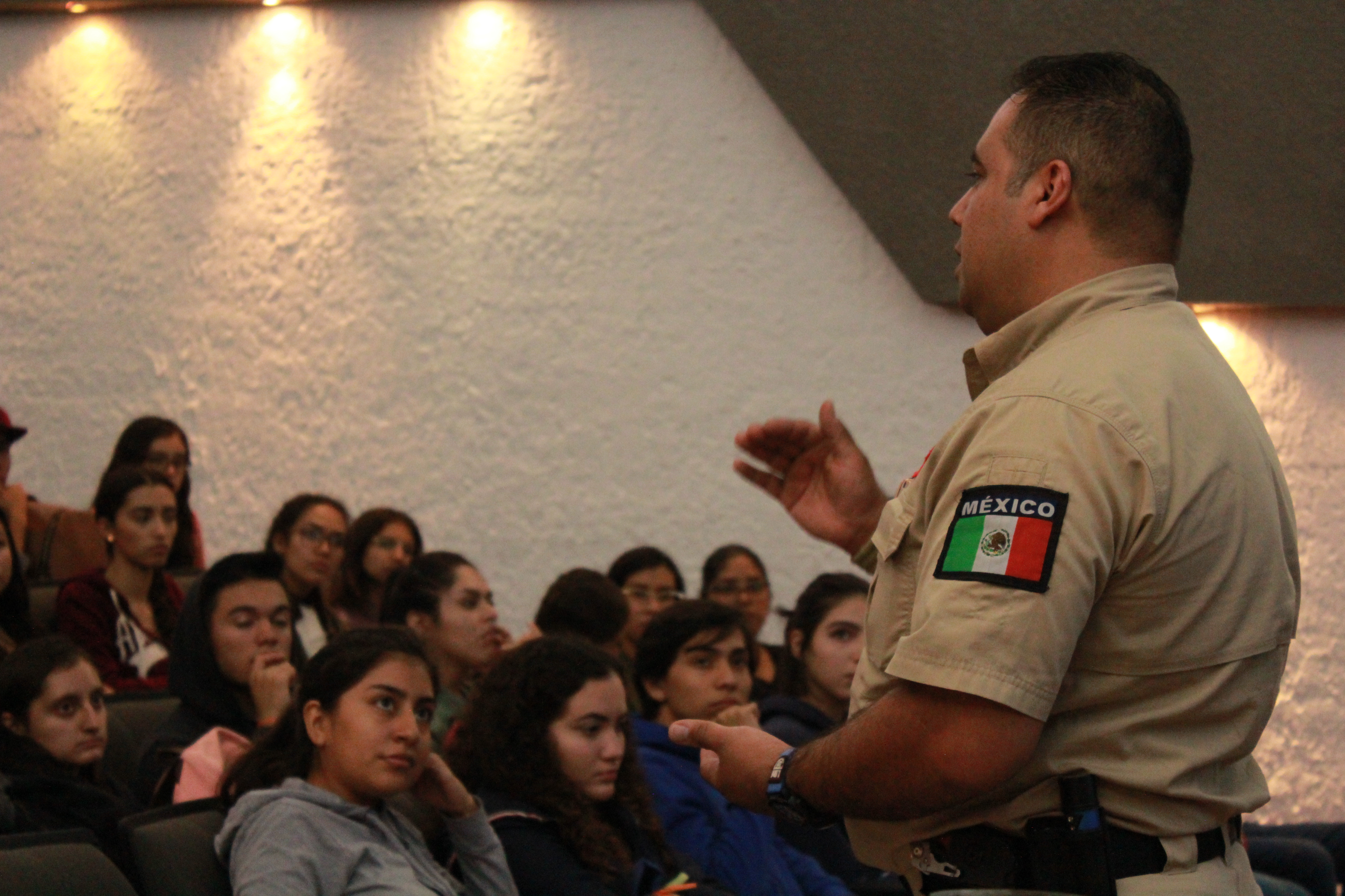 Elemento de protección civil dando plática a alumnos